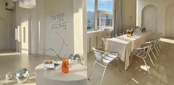 Роскошный панорамный лофт . Вид сверху. Стол с накрытой посудой. Декоративная подставка с книгами. Диско-шары на полу