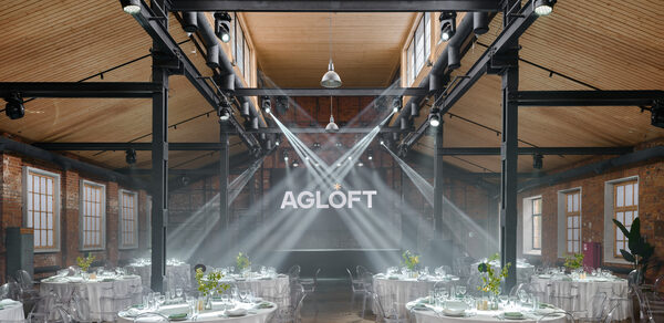 AG Loft. Urban (АГ Лофт. Урбан). Просторный лофт с раритетным автомобилем. Просторное лофт-пространство с деревянным потолком и кирпичными стенами. На полу деревянное покрытие. Расставлены круглые столы с белыми скатертями и прозрачными стульями. Яркое освещение сверху. На задней стене светящийся знак "AGLOFT". Световые прожекторы направлены к стене.