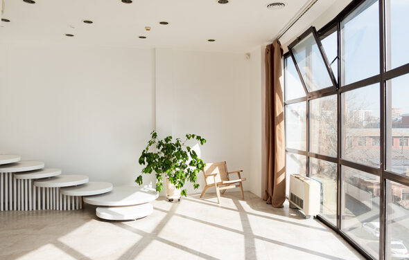 White hall with a staircase and a panoramic window