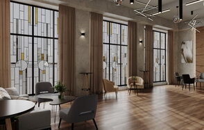 Лофт Мираж. Просторное помещение с высокими окнами в витражном стиле, серыми и бежевыми креслами, деревянным полом, декоративными светильниками на потолке. Стены серые с текстурой. Есть небольшие круглые столики и стены украшены картинами.