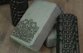 Танцевальный зал 50м2 студии RedHeartDance. Зал №3. Серые блоки с орнаментом и черные массажные ролики на деревянном полу.