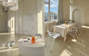 Роскошный панорамный лофт . Вид сверху. Стол с накрытой посудой. Декоративная подставка с книгами. Диско-шары на полу