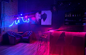 Loft space in the north of SPb. Диваны, стол. Декорация в виде дверей большого контейнера. Большая навесная люстра с несколькими лампочками. . Телевизор. Стулья. Свёрнутый экран на стене