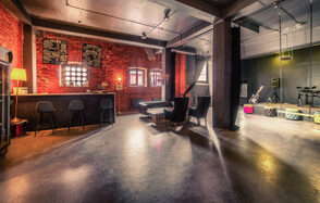 Music loft (Мьюзик лофт). Просторное лофт-пространство с кирпичными стенами, барной стойкой и черными барными стульями. Диваны и кресла создают зону отдыха. На стенах висят надписи. Освещение мягкое, индустриальный стиль. Полы серые, потолок темный. Музыкальная аппаратура в углу.